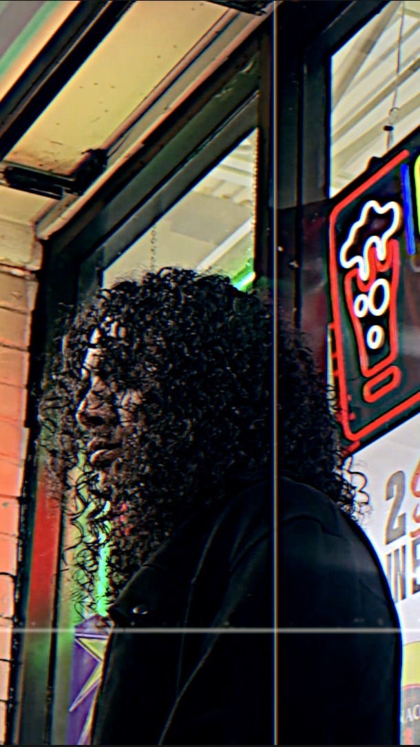 THEOFFICIALRAM beside a neon-lit storefront